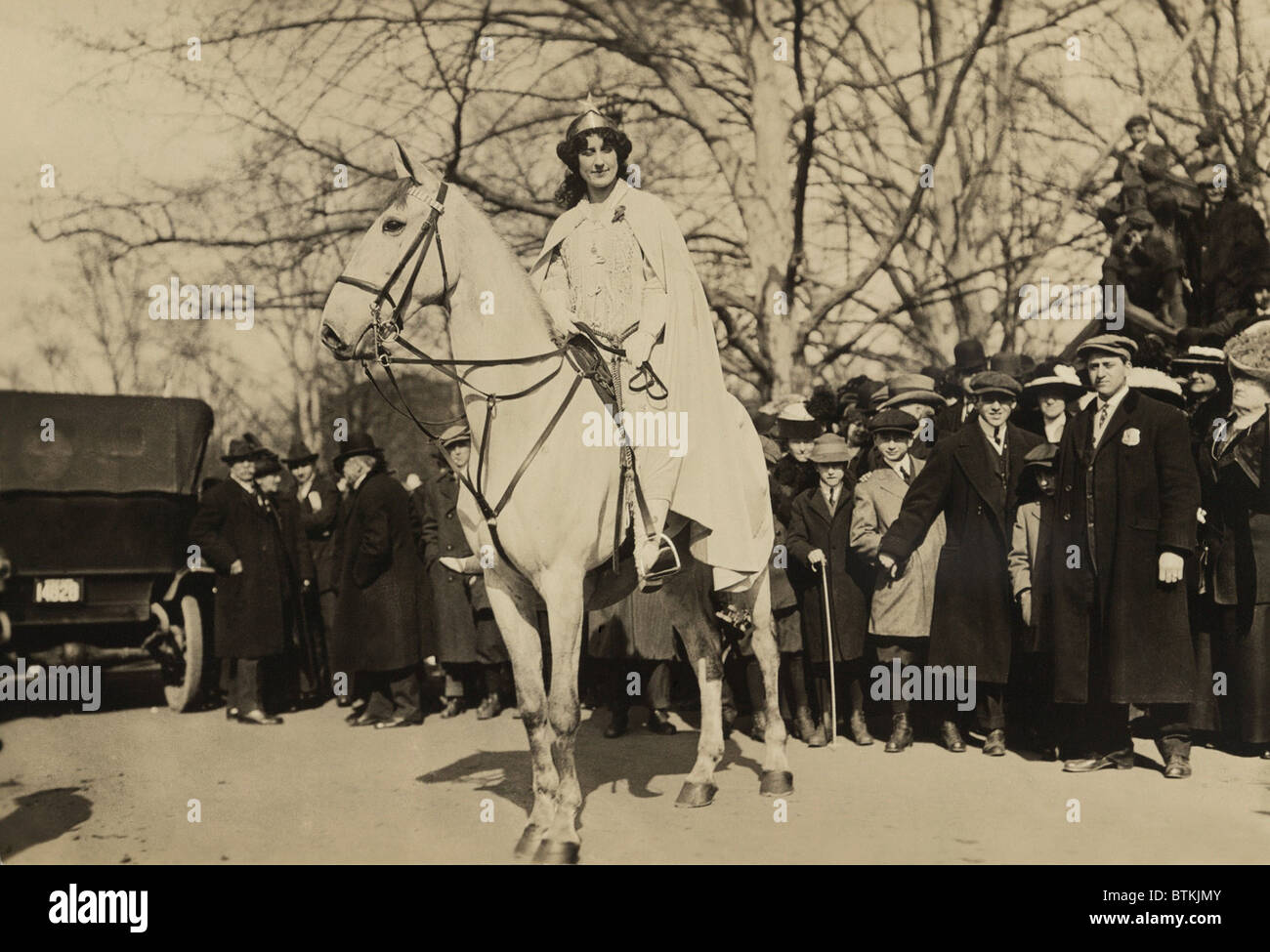 Inez Milholland, wearing white robes and a crown riding a white horse as the 'Herald' in the Women's Suffrage parade of March 3, 1913, the day prior to Woodrow Wilson's inauguration. It was the last major suffrage demonstration to use such theatrical costumes. Stock Photo