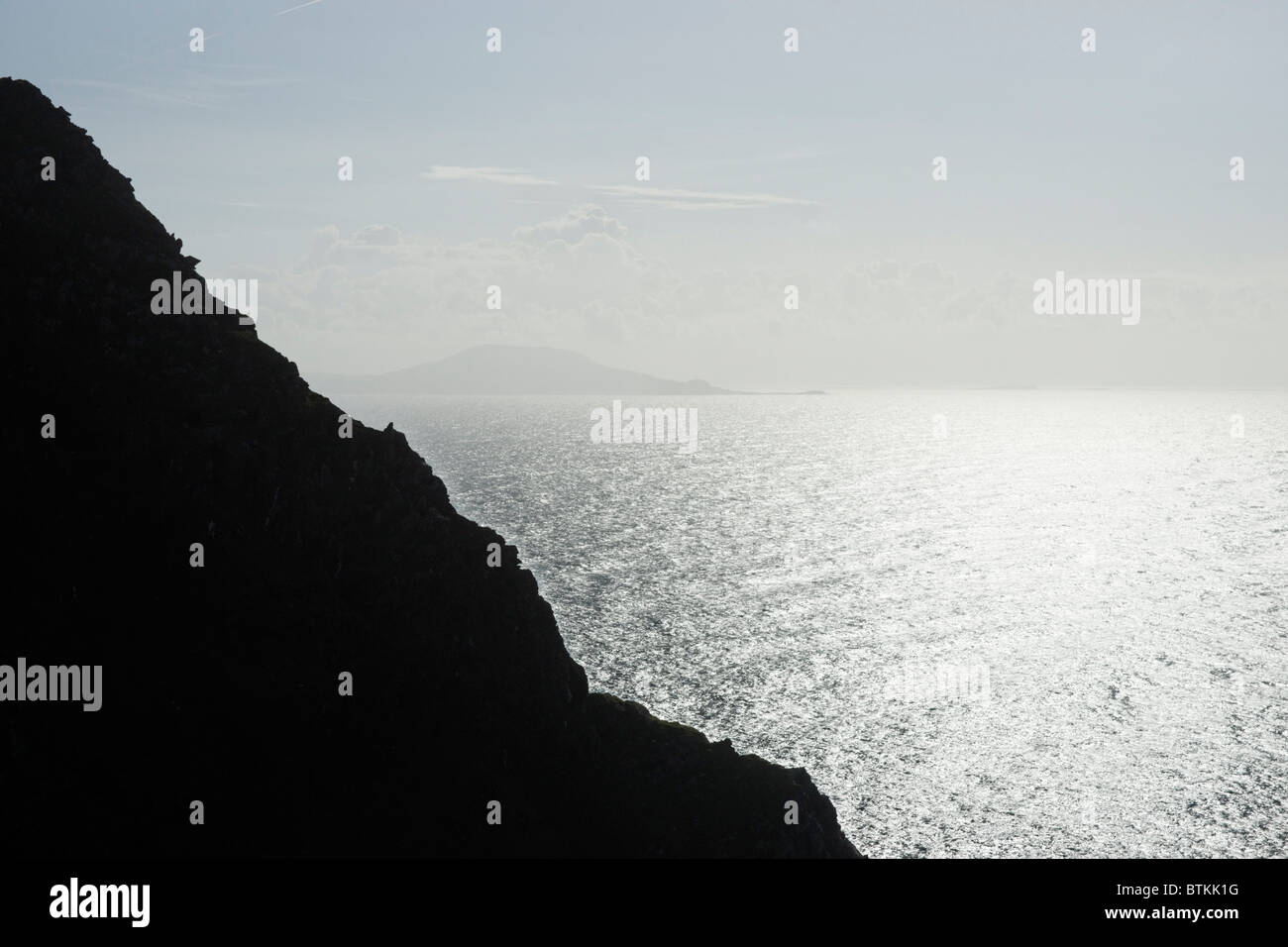 Silhouetted sea cliffs near Keem, Achill Island, County Mayo, Connaught, Ireland. Stock Photo