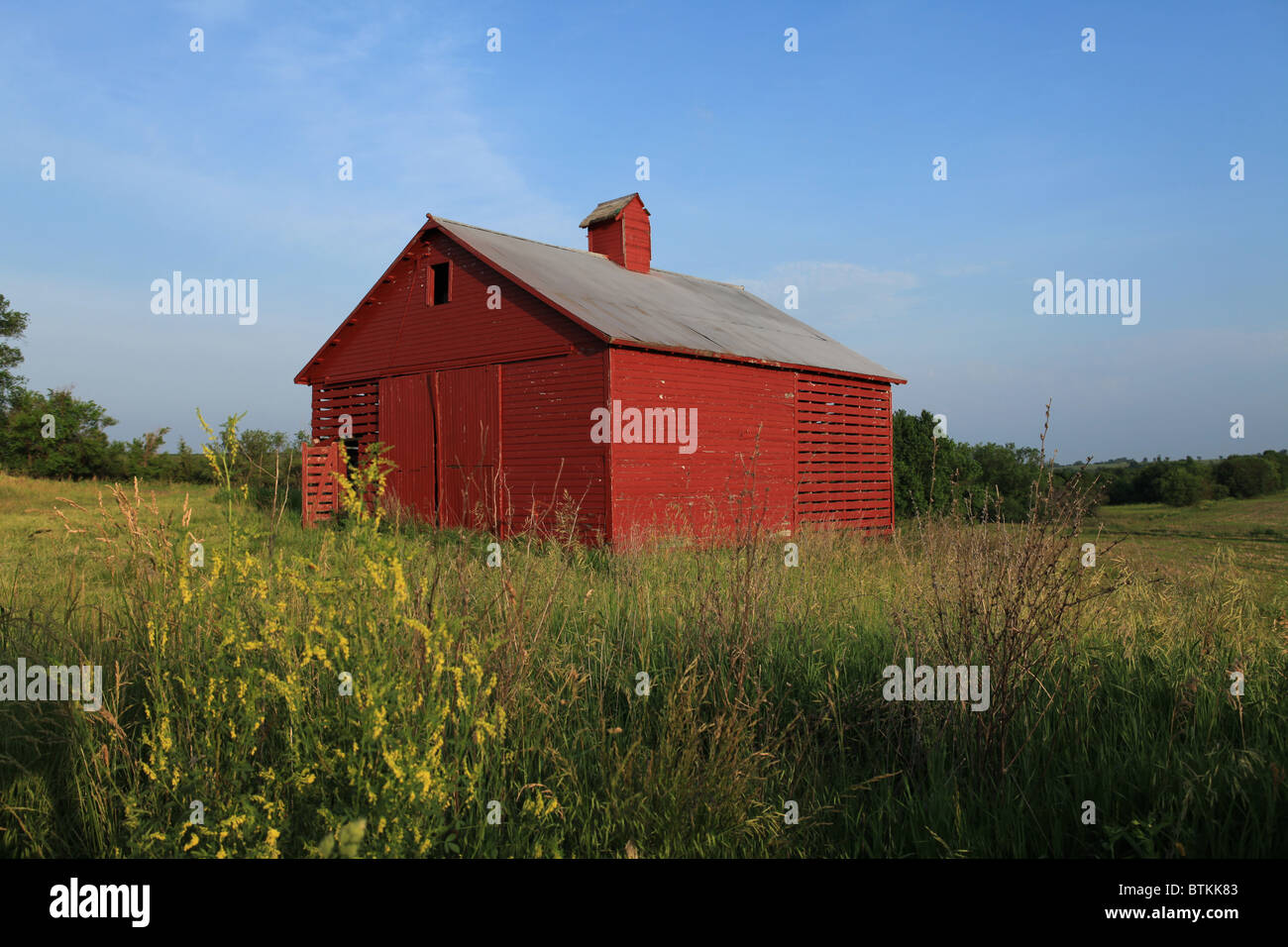 Red corn crib barn in field in southwest Iowa. Stock Photo