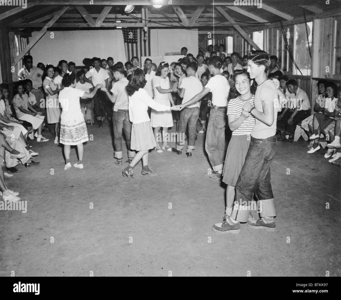 Young Japanese-Americans dancing at the Fresno, California, Assembly Center in 1942. Assembly centers were the initial organizing points, from which internees were taken to the relocation camps that would be their homes for the duration of World War II. Stock Photo
