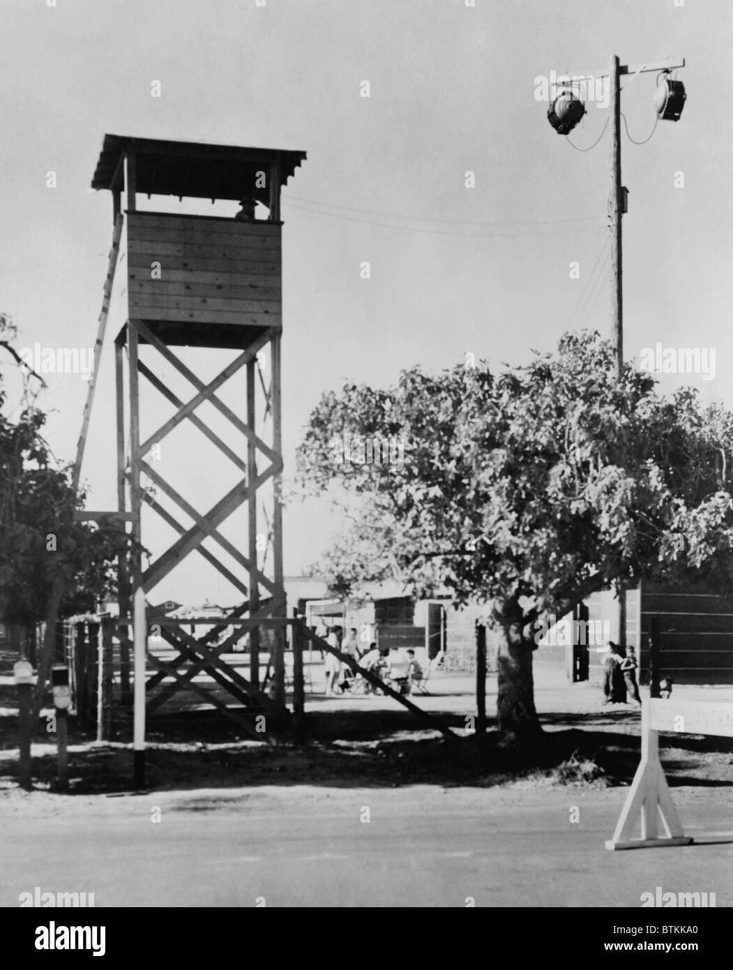 Guard tower and lights at Fresno, California, Assembly Center, where deported Japanese-Americans were first taken before routing to the relocation camps that would be their homes for the duration of World War II. 1942. Stock Photo