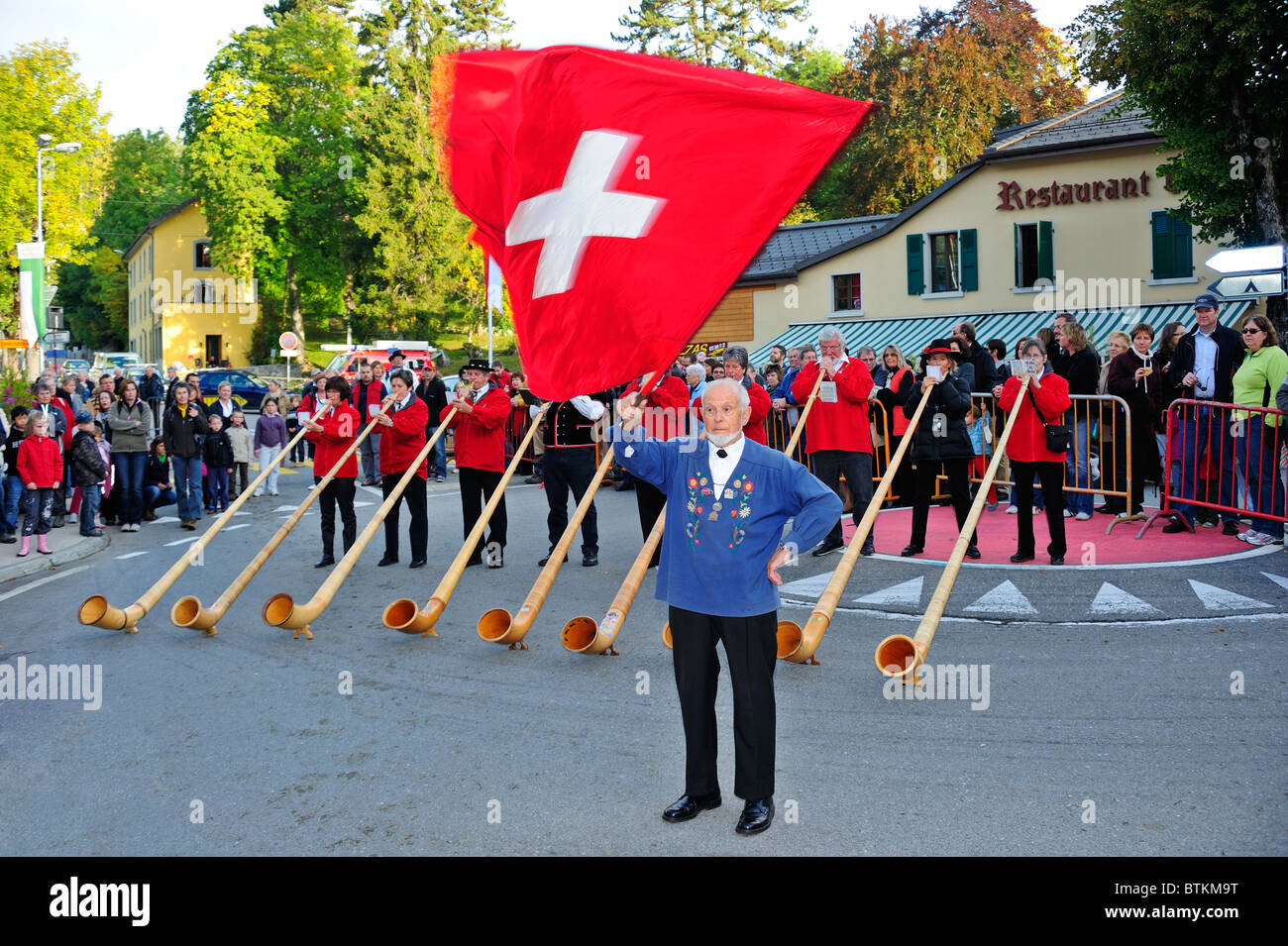 Flag throwing is a traditional activity in Switzerland, usually accompanied by alphorns playing Stock Photo