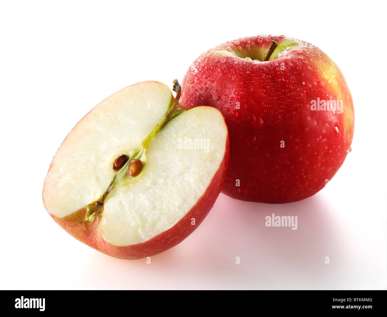 Fresh whole and sliced red Discovery apple Stock Photo