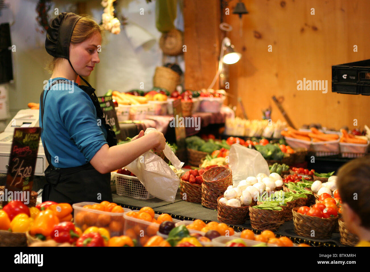 Beautiful Amish girl selling local products at St. Jacobs farmers