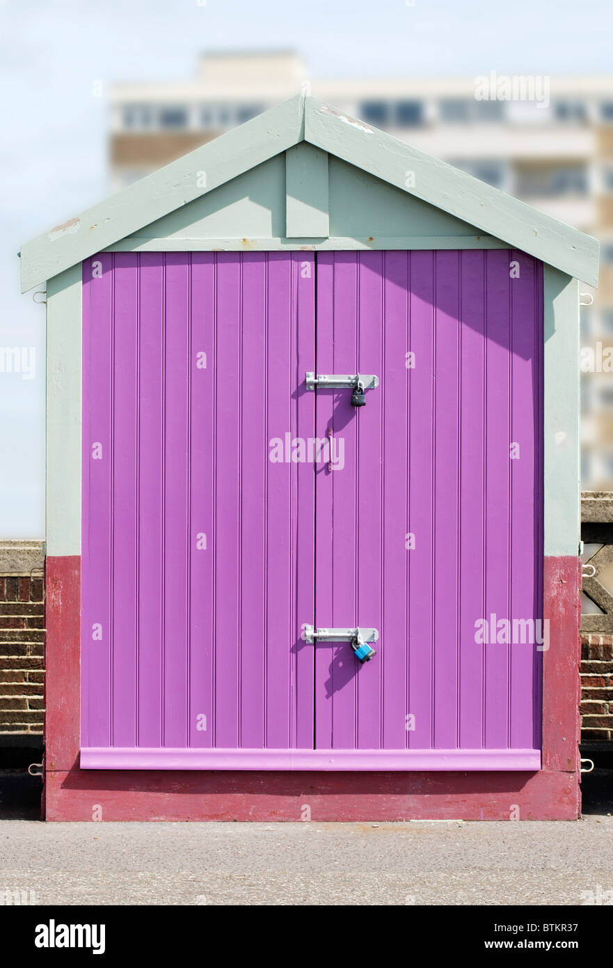 Beach hut with mauve doors on seafront promenade at Hove. Brighton