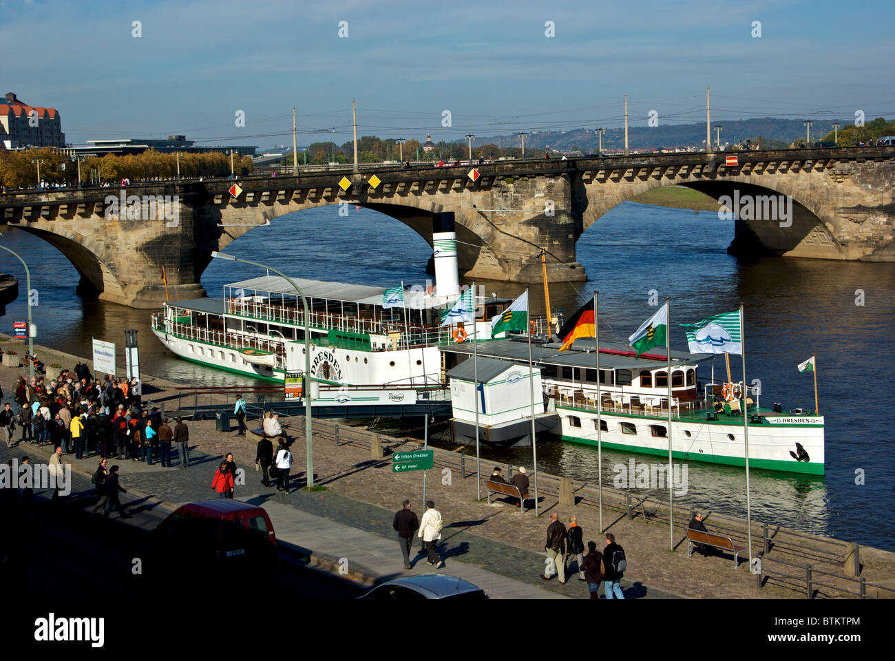 Passengers lining up to board river boat for scenic cruise tour along