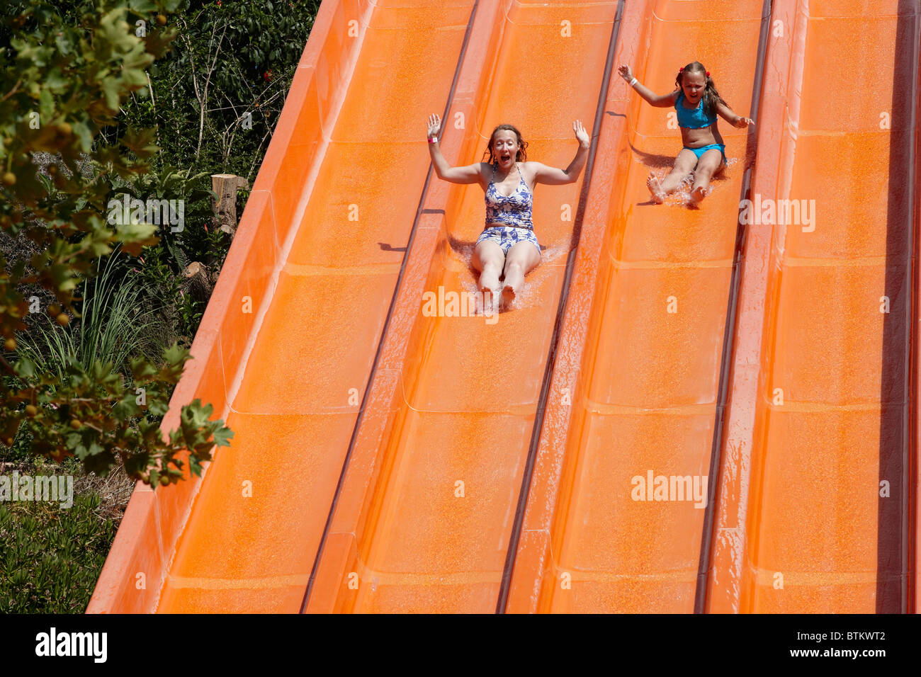 Mother and daughter water sliding together in Acqua Plus Water park. Crete, Greece. Stock Photo