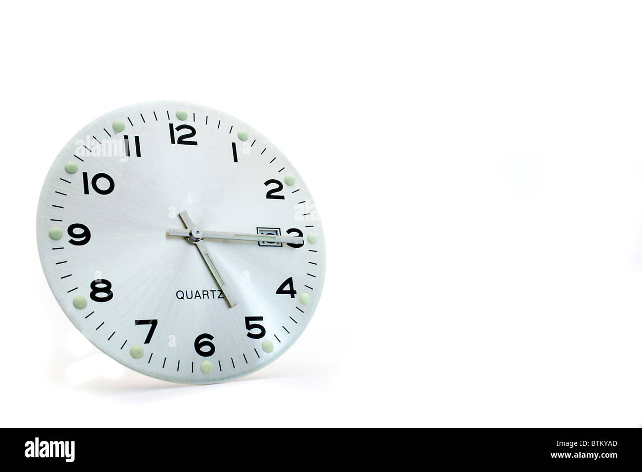 A simple clock face shows quarter past five. Time to end work. All isolated on white background. Stock Photo