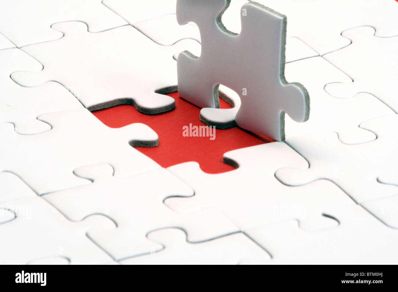 A typical jigsaw puzzle with a red gap. Stock Photo