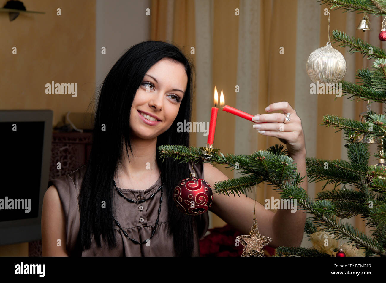 Young Woman with Christmastree at Christmas Stock Photo
