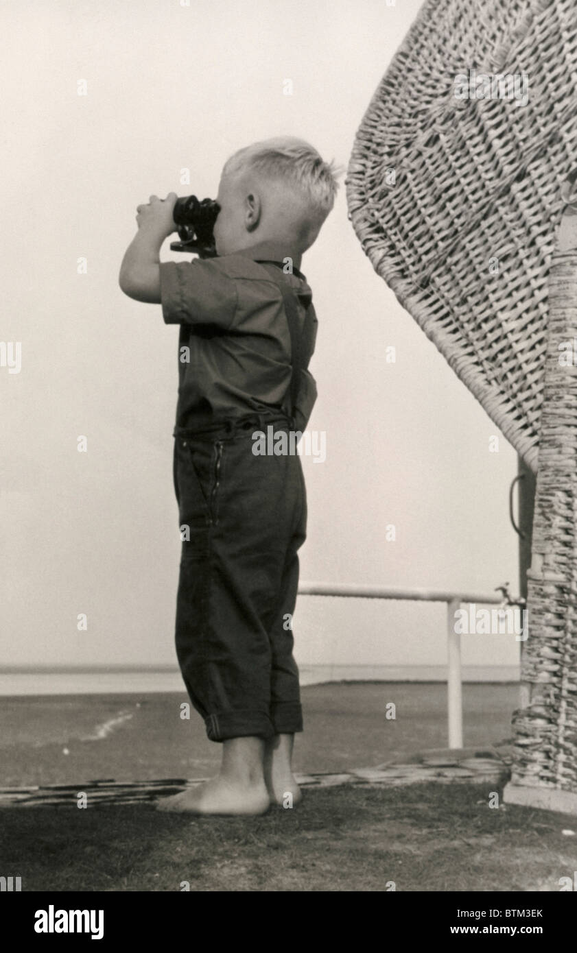 Historical photo (1910) of  a boy with binoculars Stock Photo