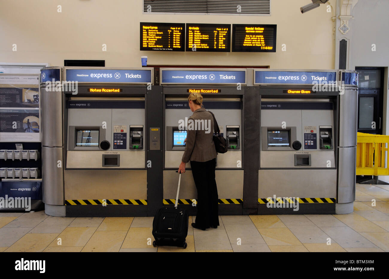 Woman purchasing a railway ticket to travel on the Heathrow Express service  from Paddington Station west London UK Stock Photo - Alamy