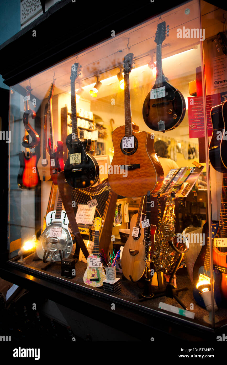 Guitars in the window of a small locally owned specialist music shop, Aberystwyth Wales UK Stock Photo
