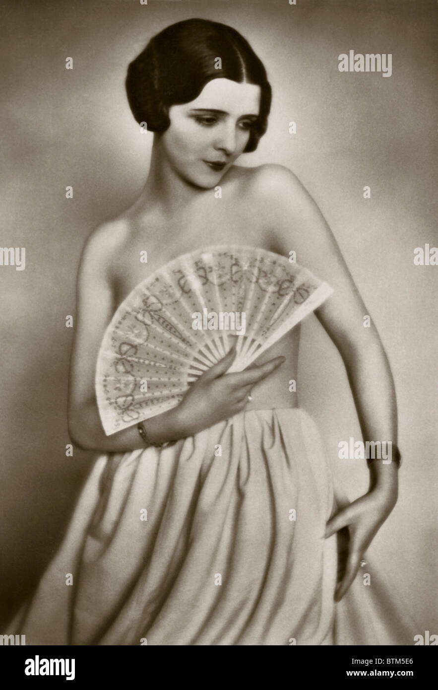 Historical photo (1910) of a woman with a fan Stock Photo