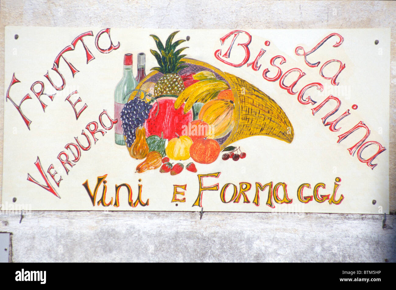 Sign outside shop selling fruit, vegetables, wine, and cheese, in Taormina Sicily Stock Photo