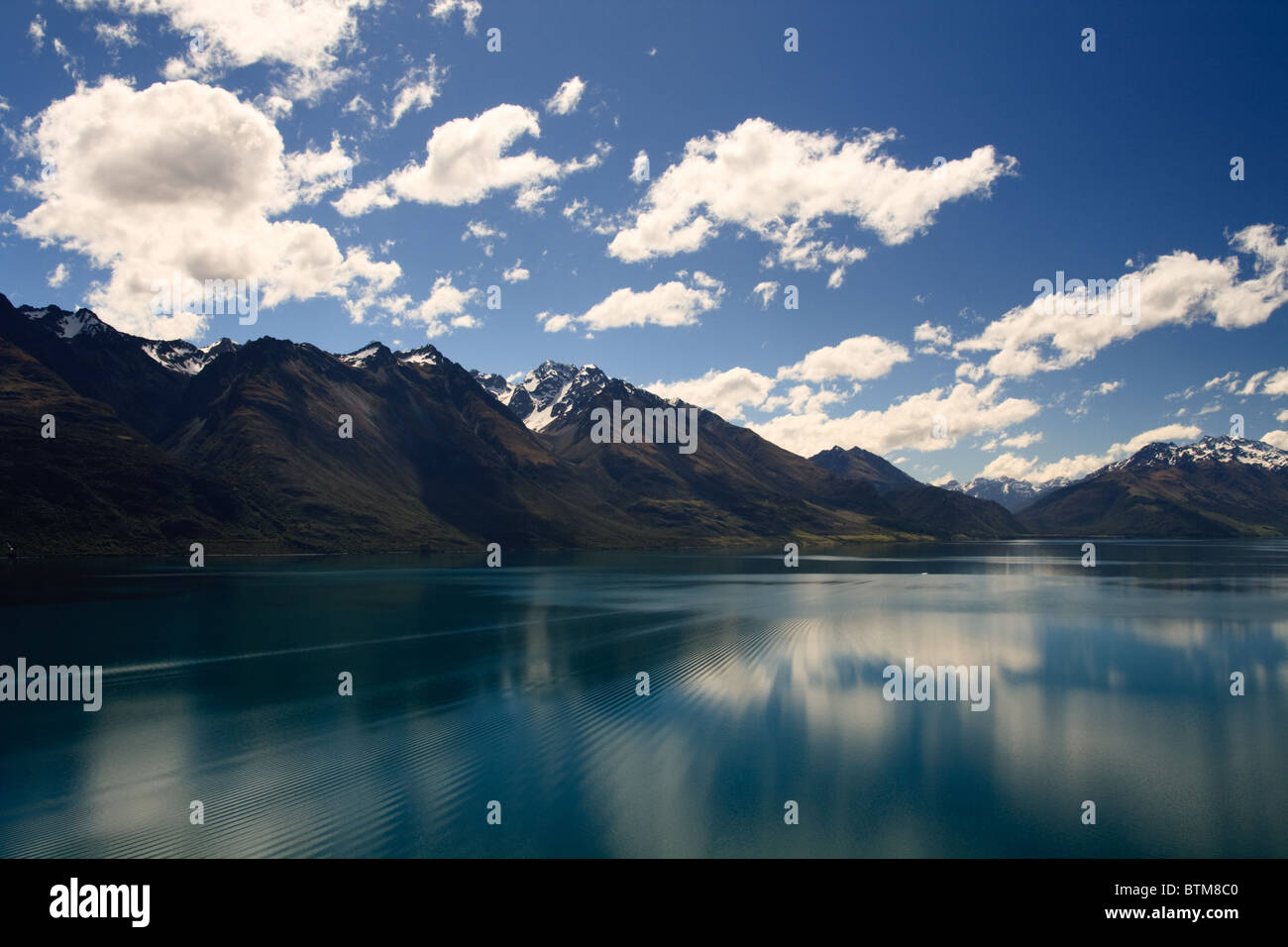 Reflection from Lake Wakatipu surrounded by mountains near Queenstown, South Island, New Zealand Stock Photo