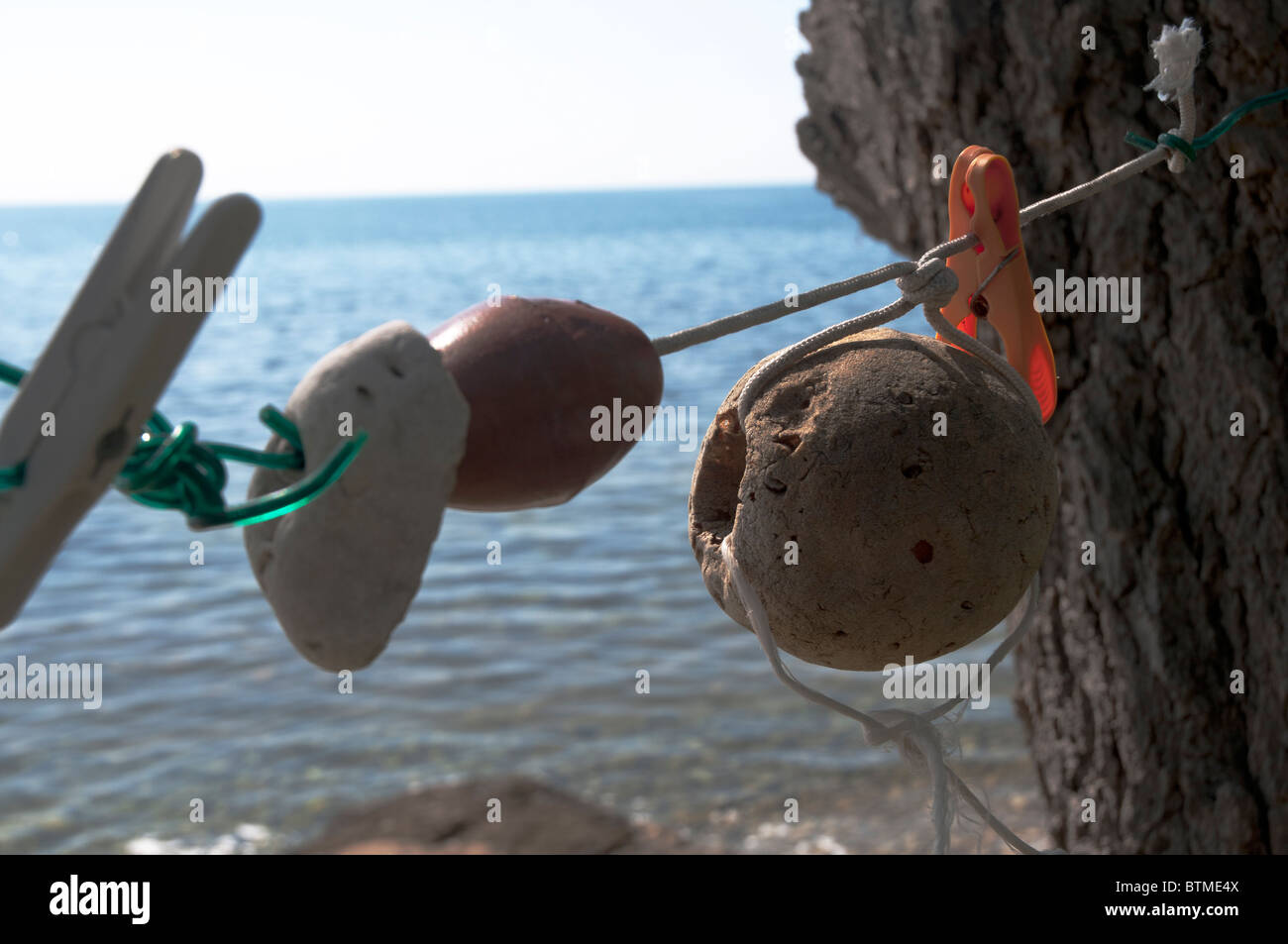 fishing floats hang from string along tranquil quiet fishing village in