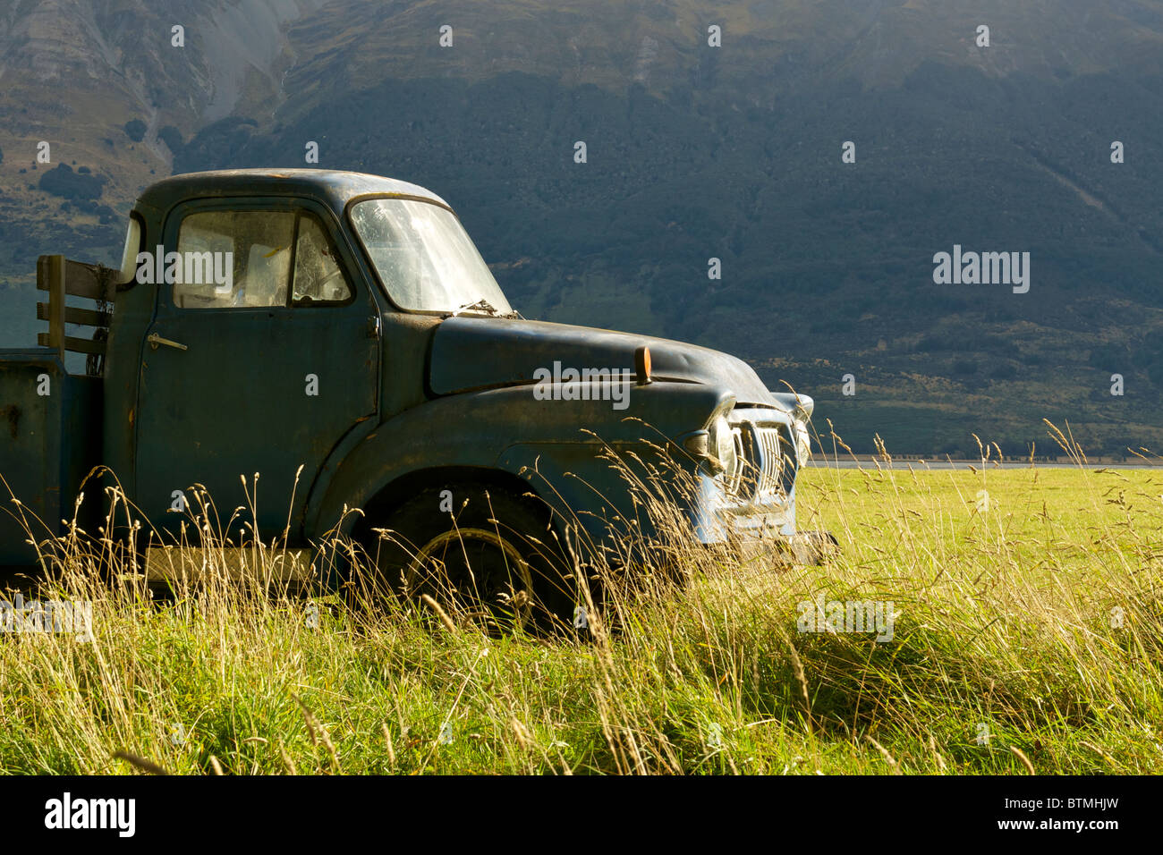 An old pickup truck in a grassy field Stock Photo - Alamy