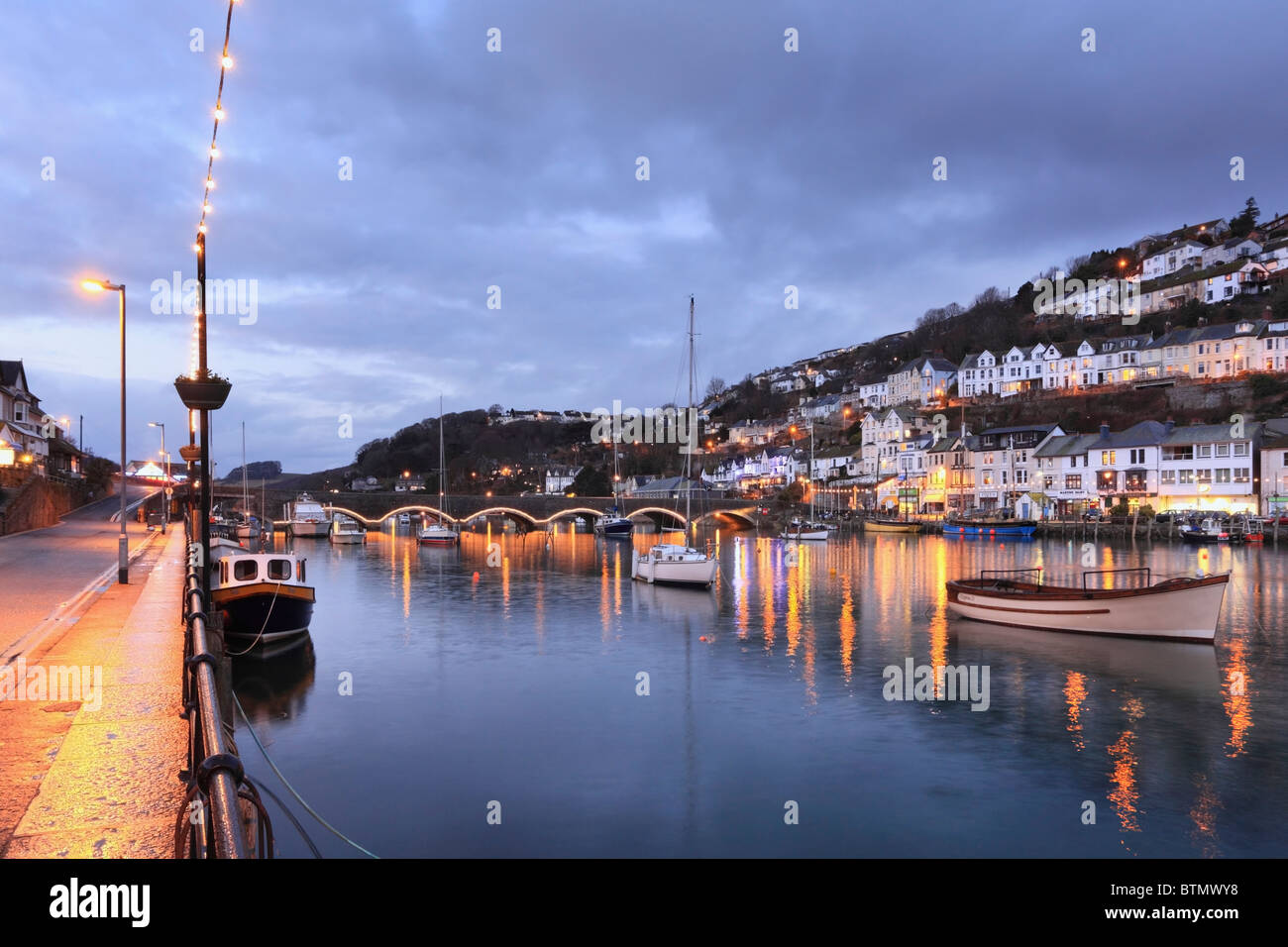 Boats on Looe River in south east Cornwall captured during twilight on a still winters evening. Stock Photo