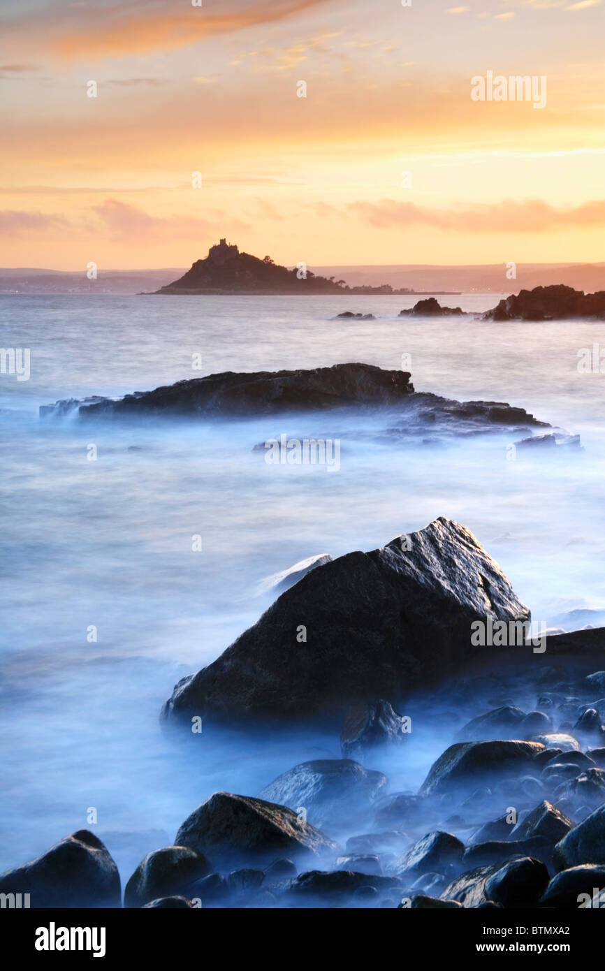 St Michael's Mount captured at sunset using a long shutter speed to blur the water Stock Photo