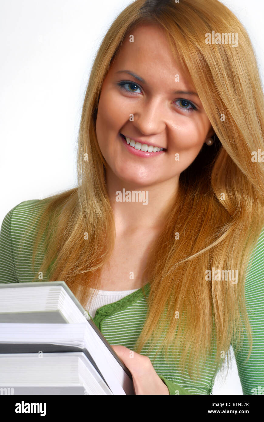 Portrait of a beautiful young female student, holding books Stock Photo