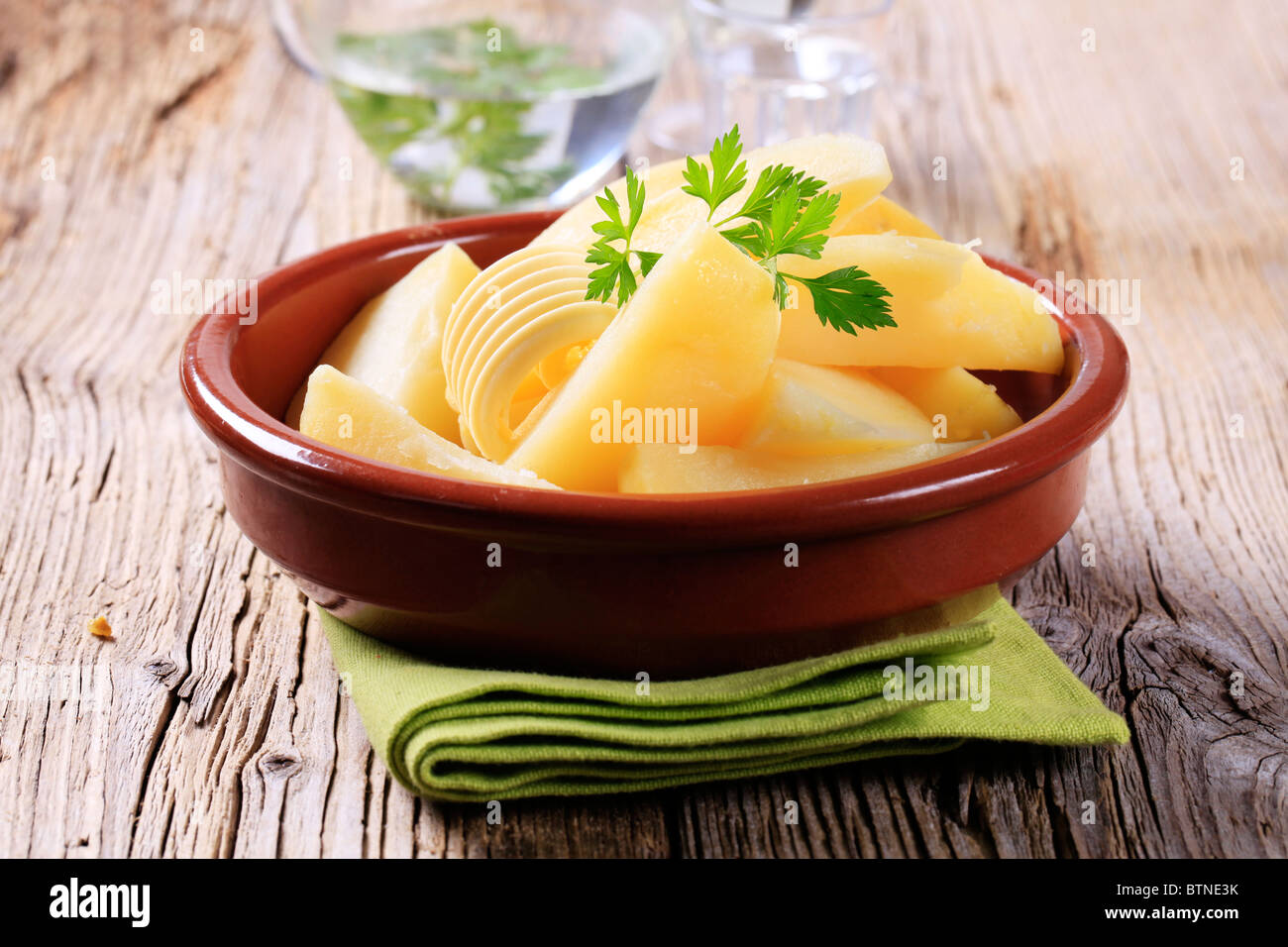 Boiled potatoes and a curl of butter Stock Photo