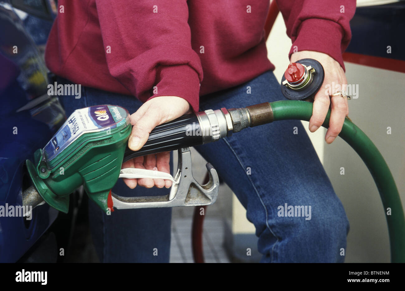 person putting petrol in car Stock Photo Alamy