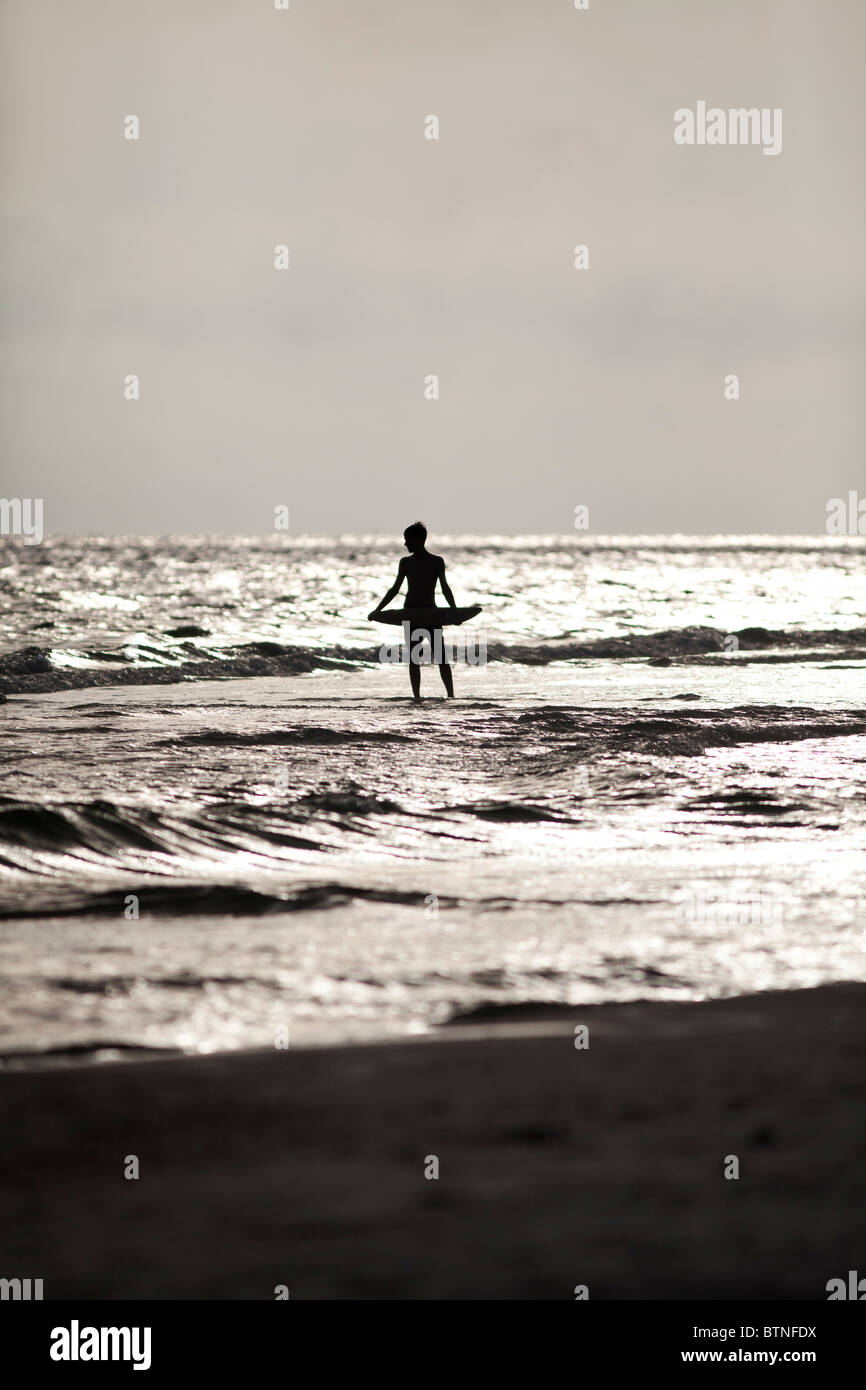 A distant person facing the ocean at sunset. Panama City Beach, Gulf Coast, Florida. Stock Photo