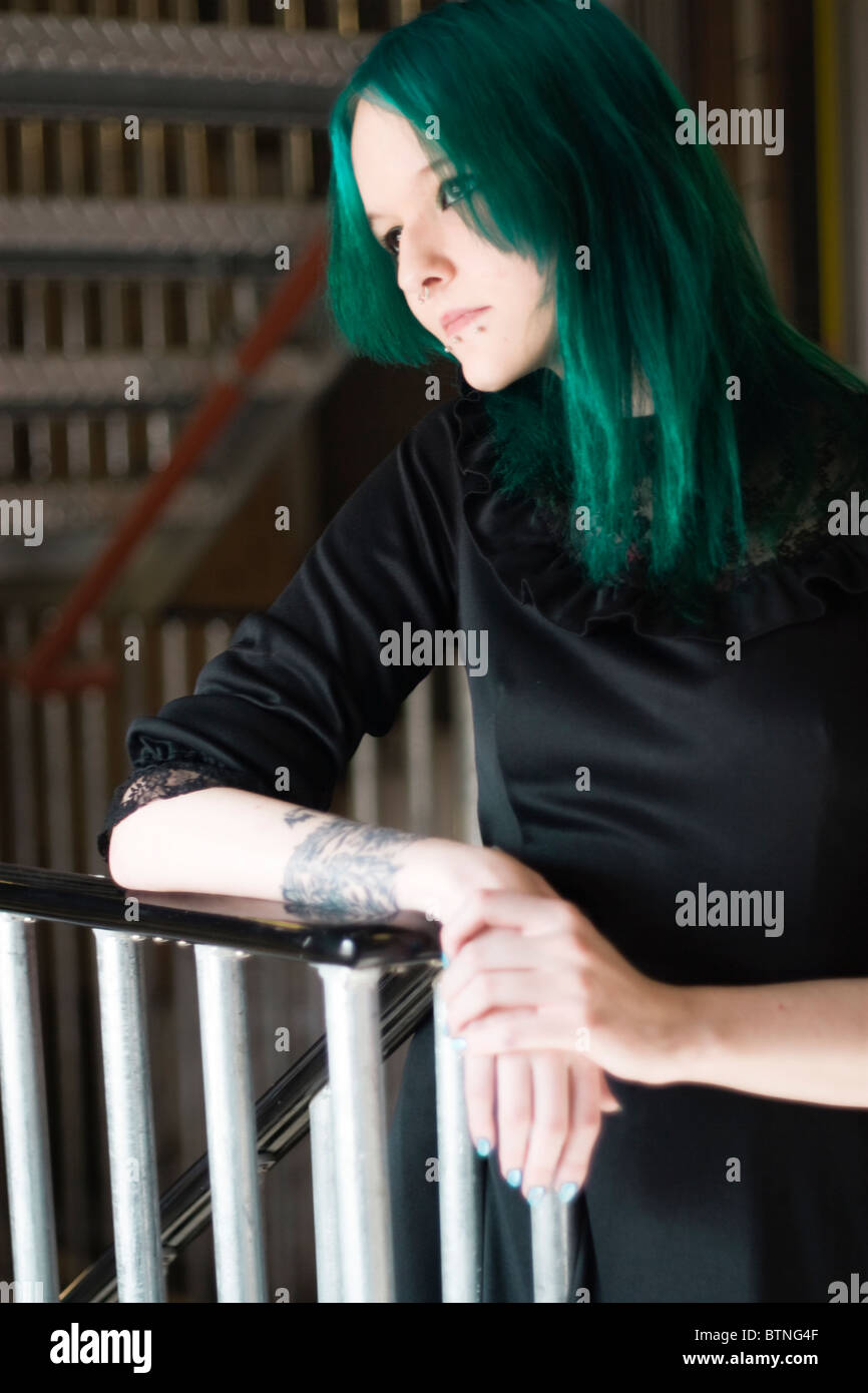 A young goth woman with green hair wearing a green dress and standing in a fire escape Stock Photo - Alamy A young goth woman with green hair wearing a green dress and standing in a fire escape Stock Photo - Alamy