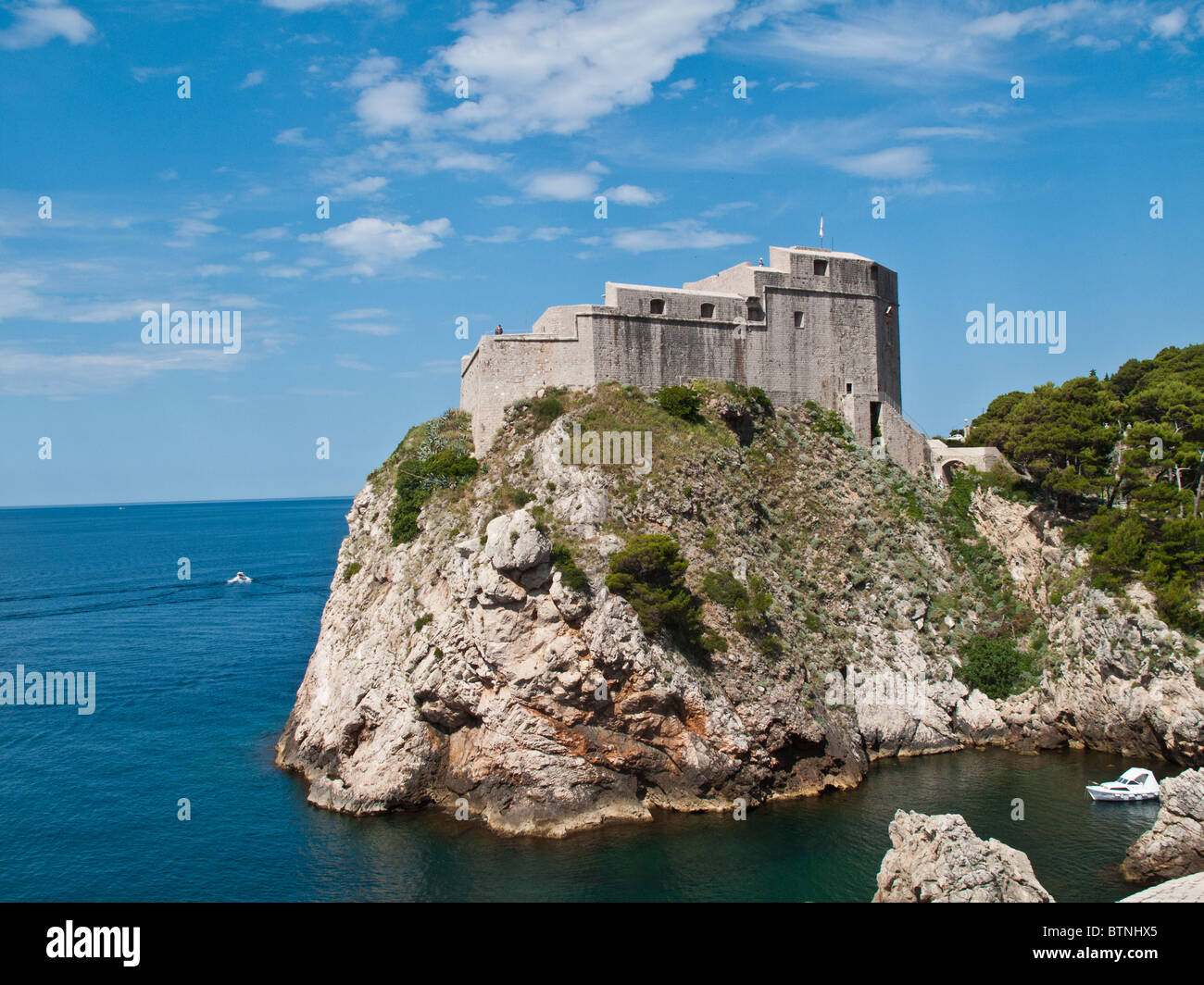 Ancient fortress on the cliff edge of Dubrovnik protects the port Stock Photo