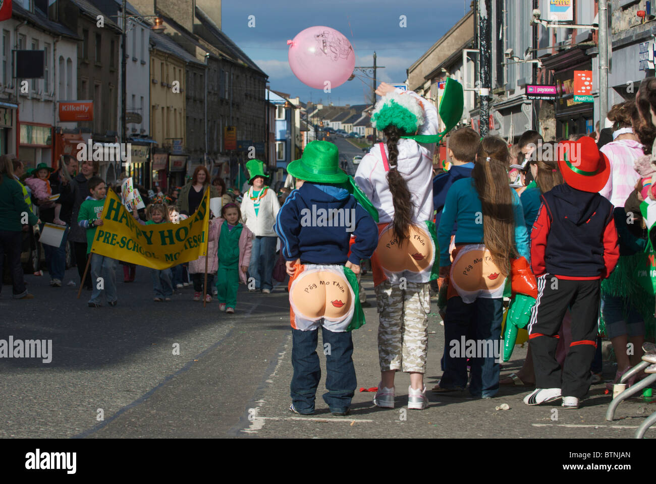 Spectators wearing comic costumes while watching the St. Patrick's day