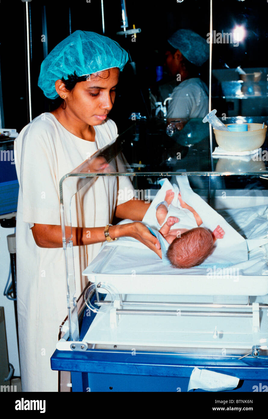 Nurse caring for baby in the maternity unit of the general hospital in