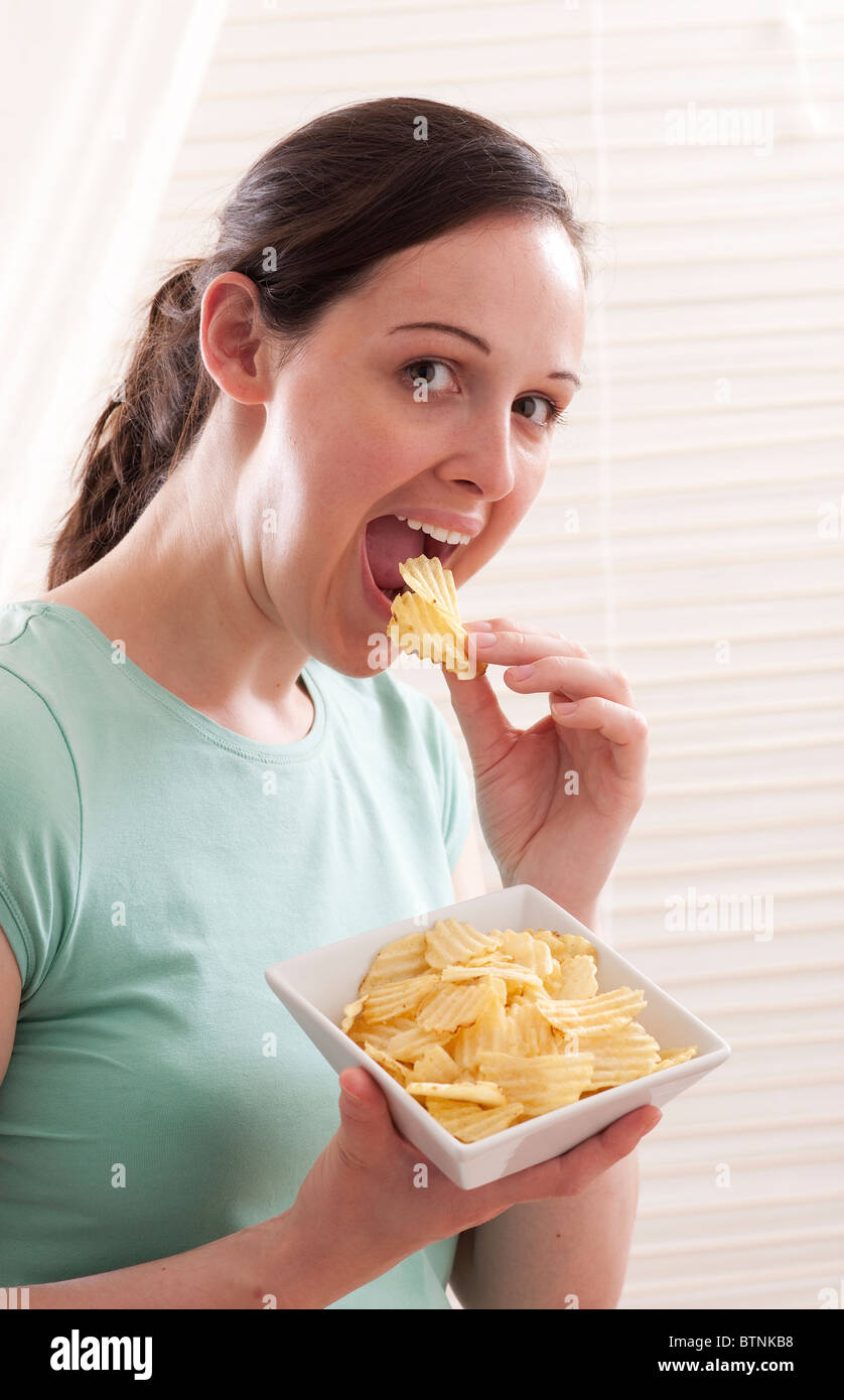 teeen eating crisps Stock Photo