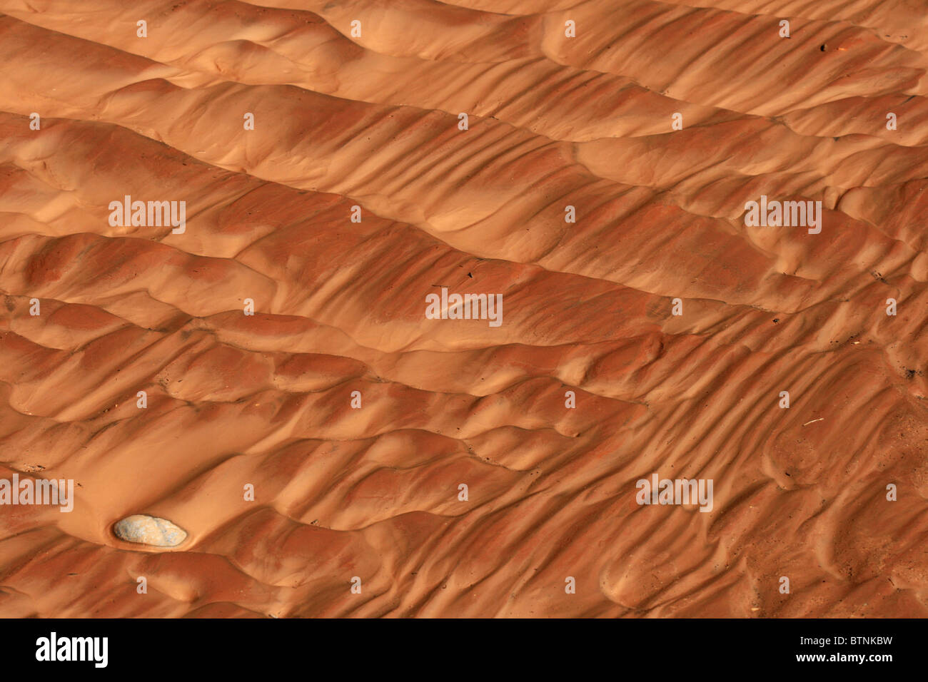 reddish sand and mud ripples in the San Juan River bank Stock Photo