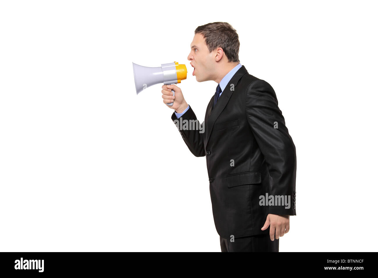An angry businessman announcing via megaphone isolated against white background Stock Photo