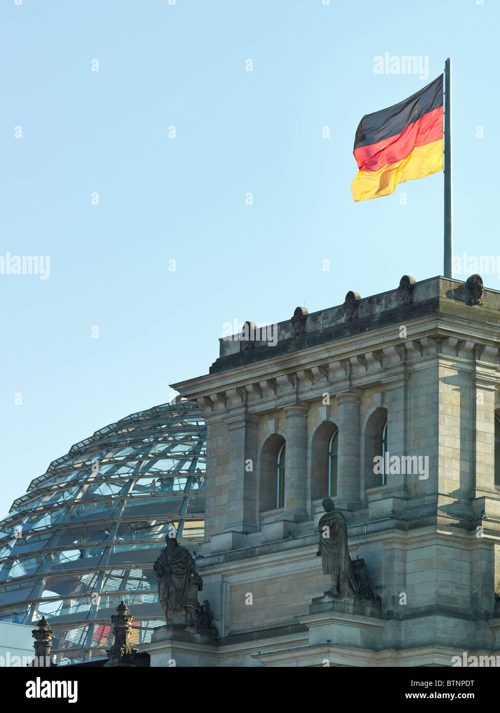 Berlin Reichstag building (German Parliament) in detail view with glass dome by Norman Foster and German flag. High Res shot. Stock Photo