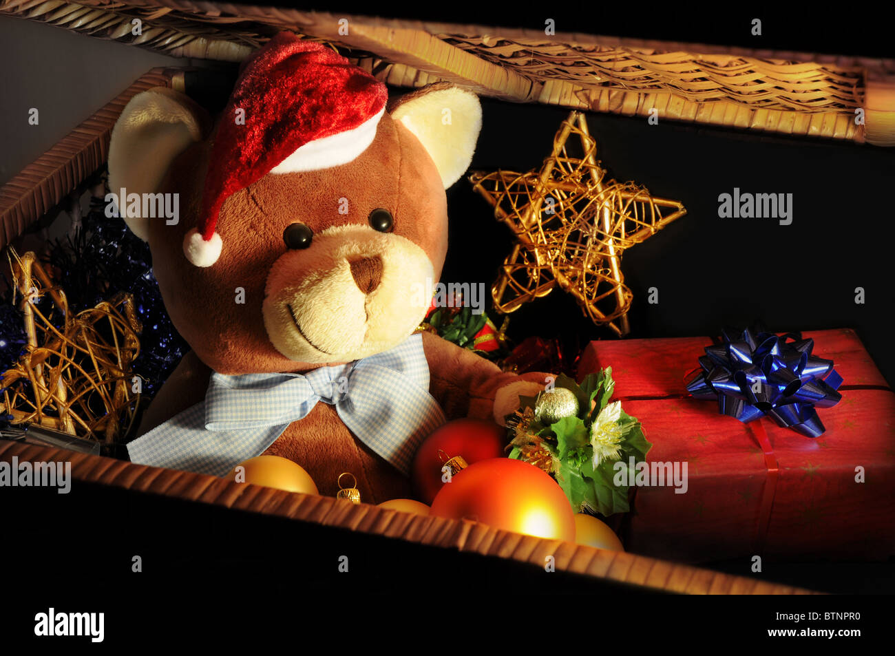 Christmas expectations concept - teddy bear in a chest with Christmas decoration and gifts. Stock Photo
