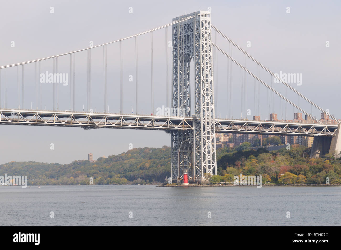 The Little Red Lighthouse under the George Washington Bridge once warned ships on the Hudson River away from Jeffrey's Hook. Stock Photo
