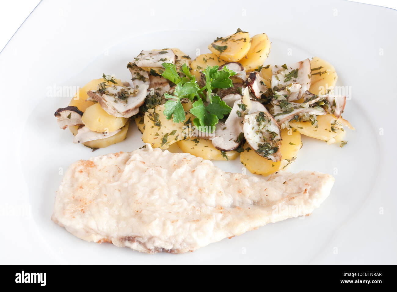 chicken escalope with baked potatoes and mushrooms isolated on white with clipping path Stock Photo