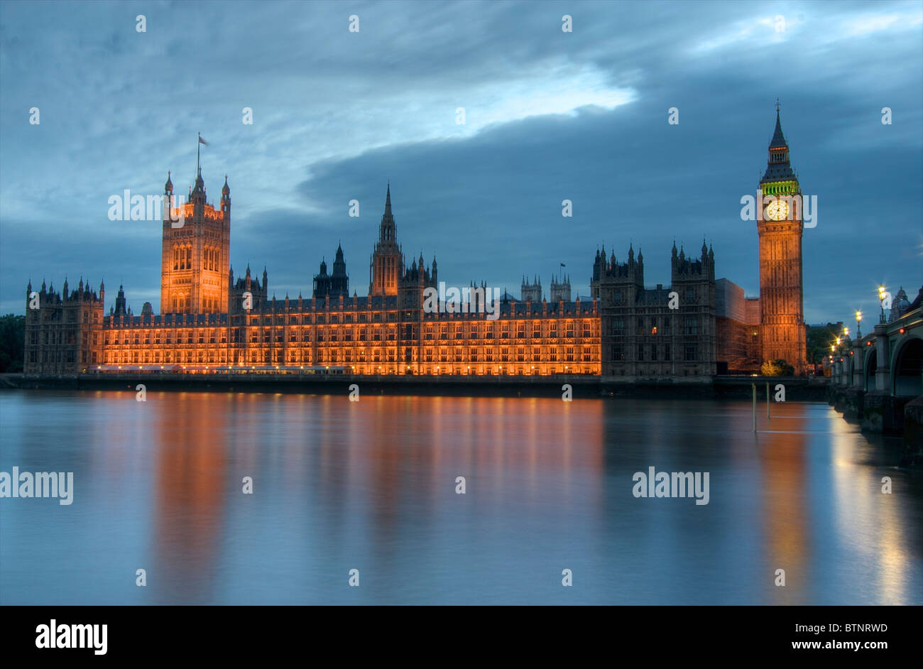 Houses of Parliament reflects in the Thames in London, UK Stock Photo