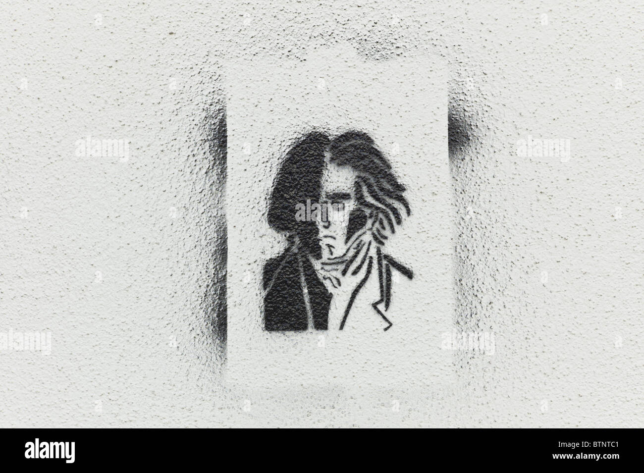 Stencil / Graffiti showing a portrait of Beethoven on a bright wall in Schwabing, Munich Stock Photo