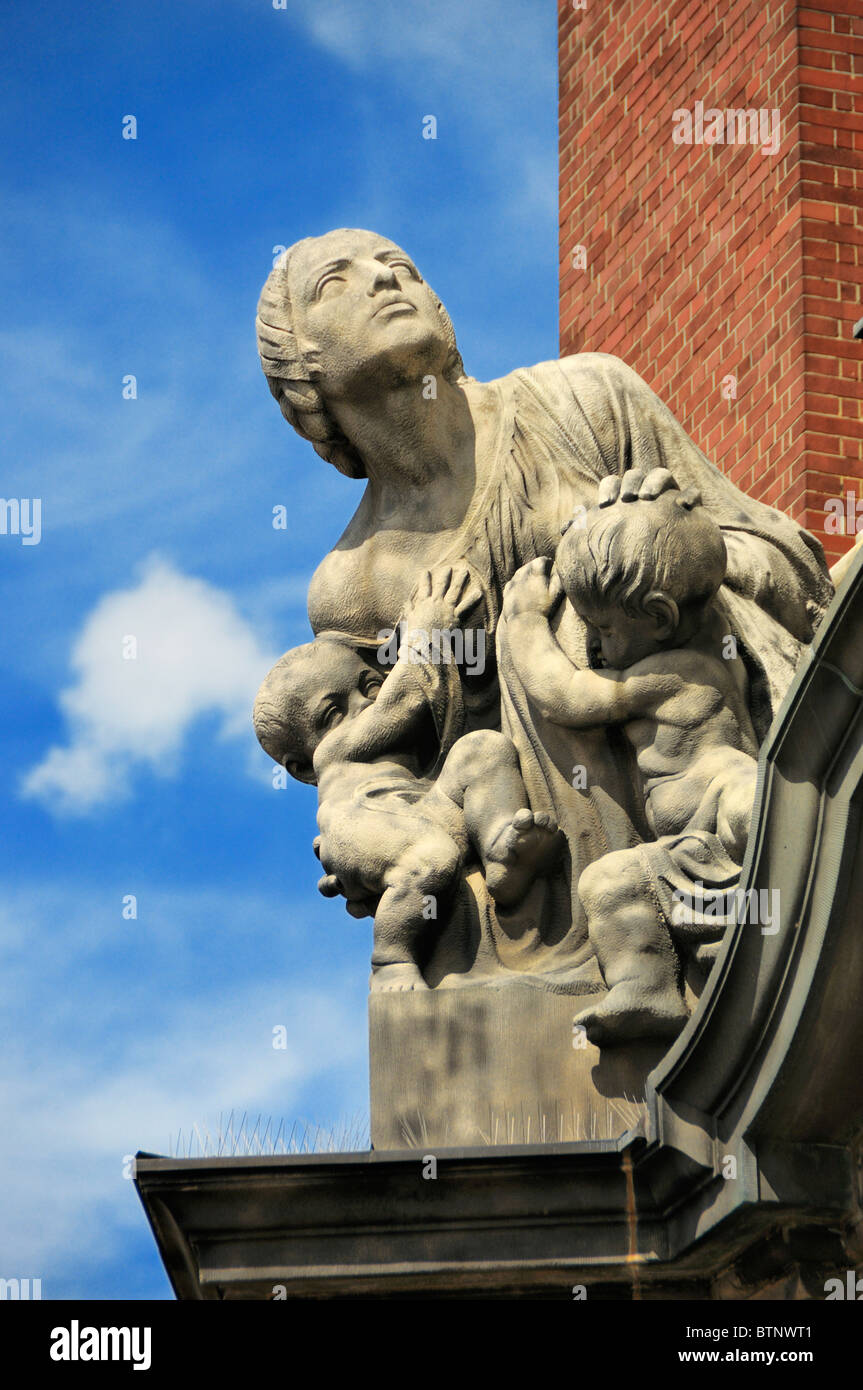 Sculptures (woman protecting children from the devil) above the main entrance to the St. Michaelis Church in Hamburg, Germany. Stock Photo