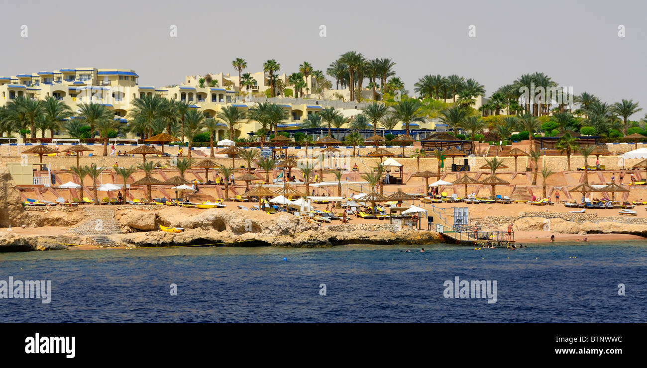 The typical rocky beach of the resort hotel just north of Sharm El Sheik, south east coast Sinai Peninsula, Red Sea, Egypt. Stock Photo