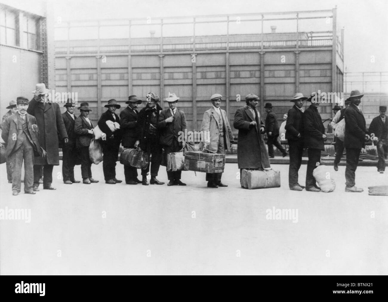 Vintage photo circa 1911 of immigrants queuing up to be processed at Ellis Island in New York. Stock Photo