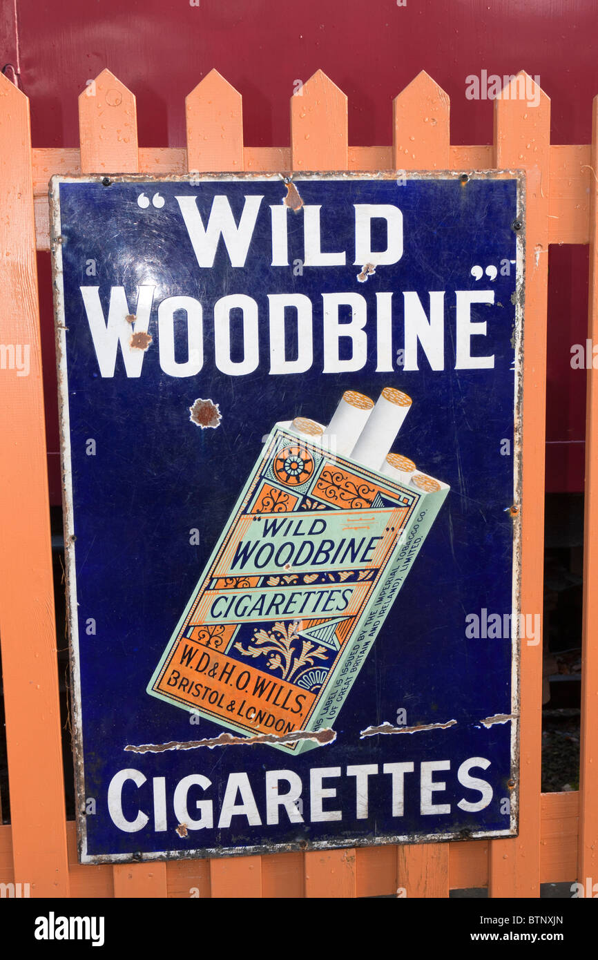 Old fashioned metal advertising sign on display at a  '[steam railway station' Stock Photo