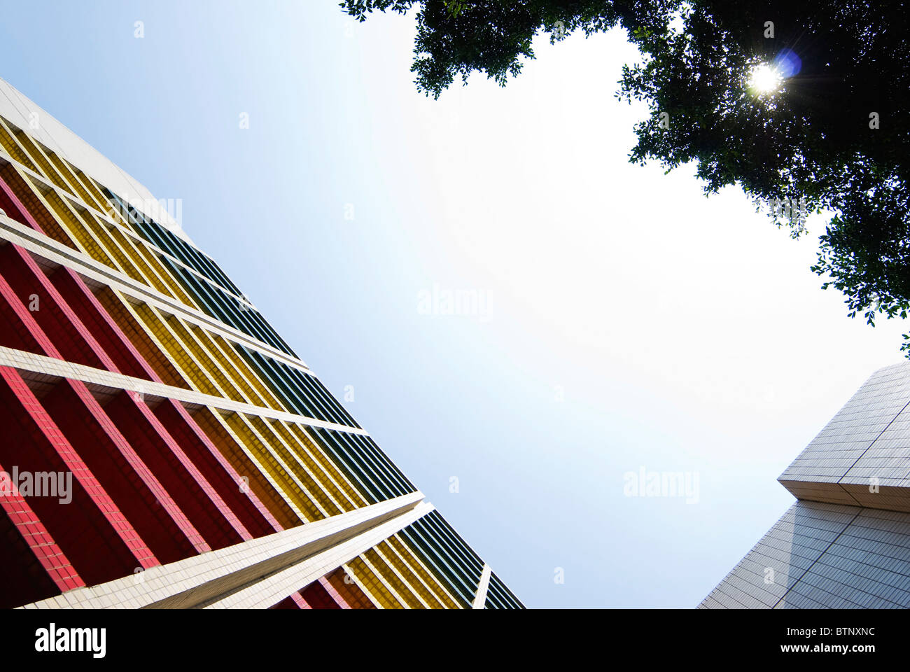 Colorful modern building extend to blue sky. Stock Photo