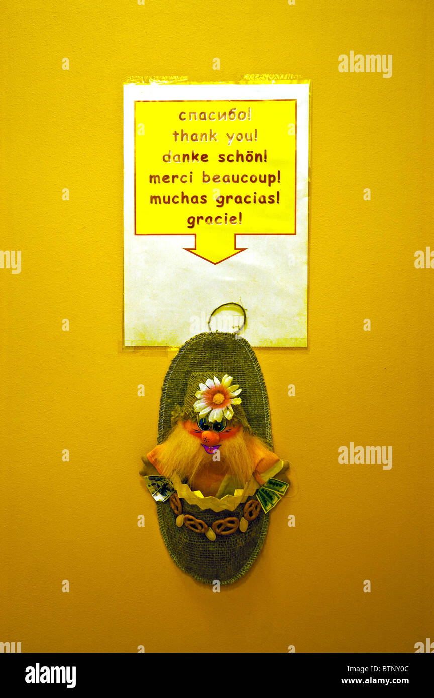 A humorous reminder for a tip with a Troll in a purse and a thank you  notice in several languages, St Petersburg, Russia Stock Photo - Alamy