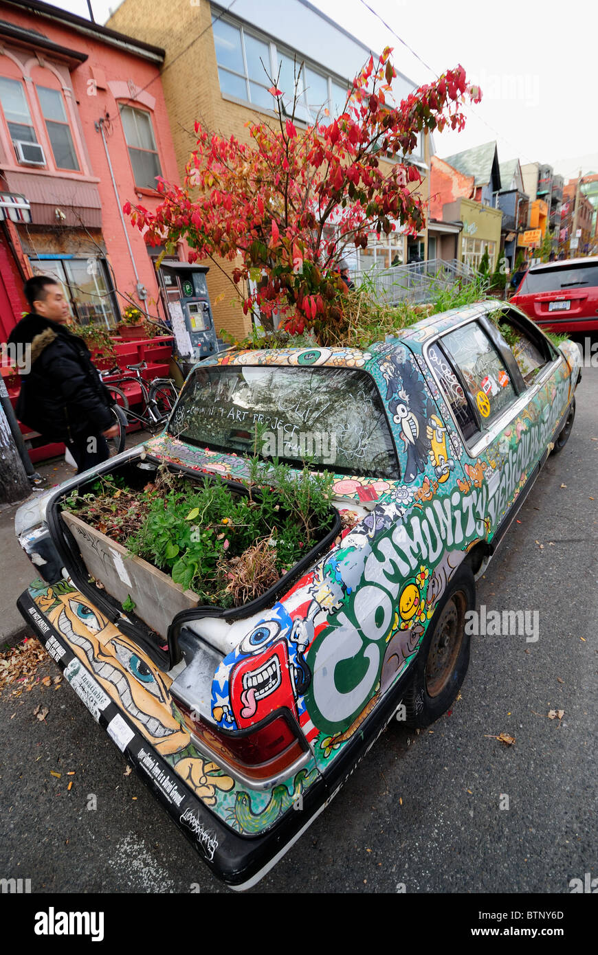 A car filled with soil and plants is part of a long standing