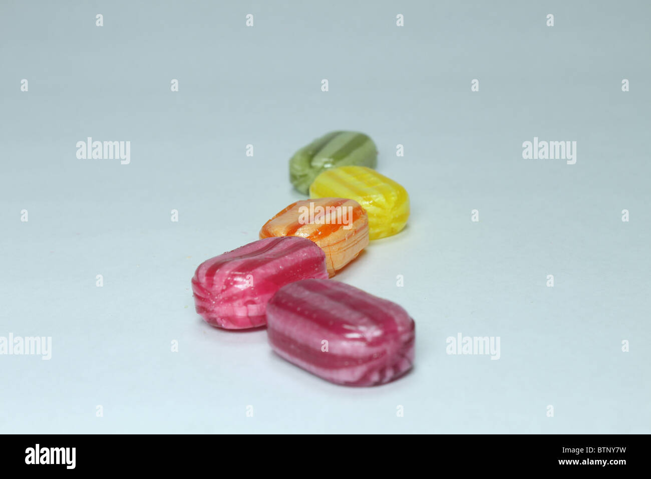 Boiled sweets in a line Stock Photo