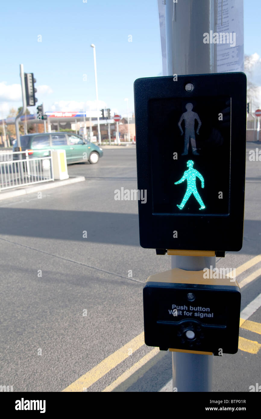 A new illuminated green man sign on a crossing in a street in Nottingham UK Stock Photo
